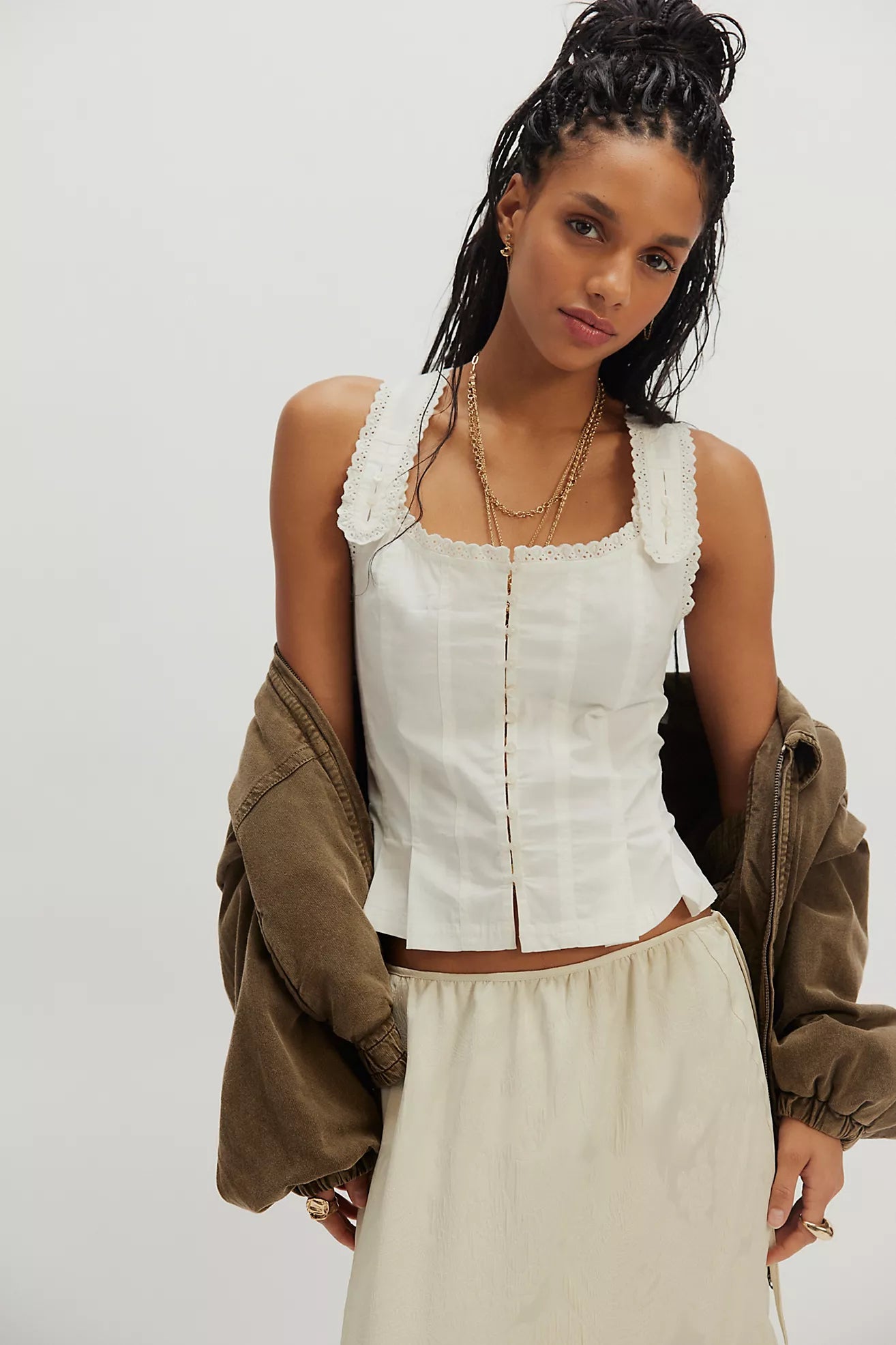 Ivory corset top with scalloped lace straps and vertical button placket