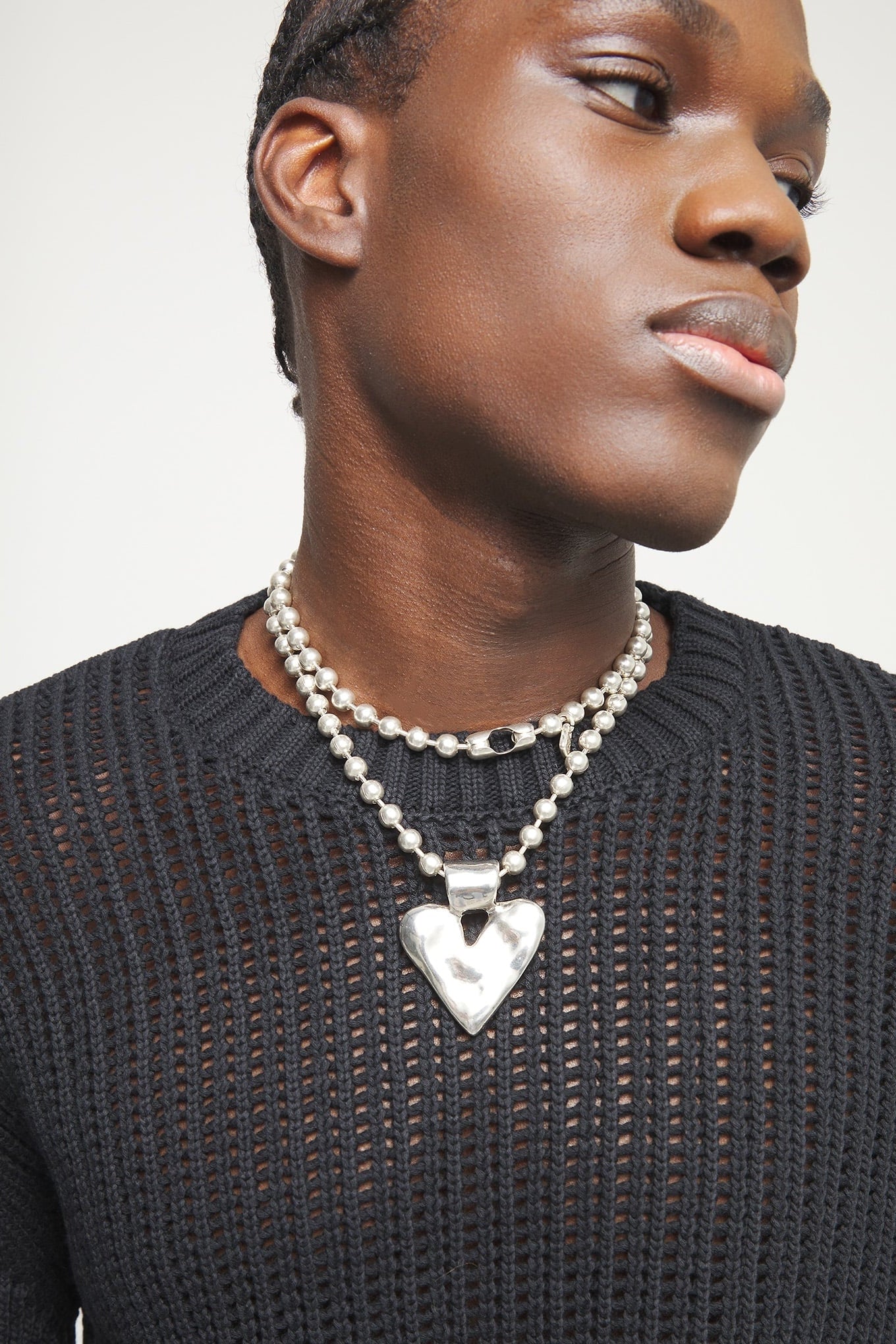 Silver-tone long heart pendant necklace with ball chain, close-up