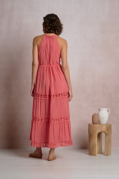Maxi halter dress in bright pink, back view with tiered ruffles and lace trim