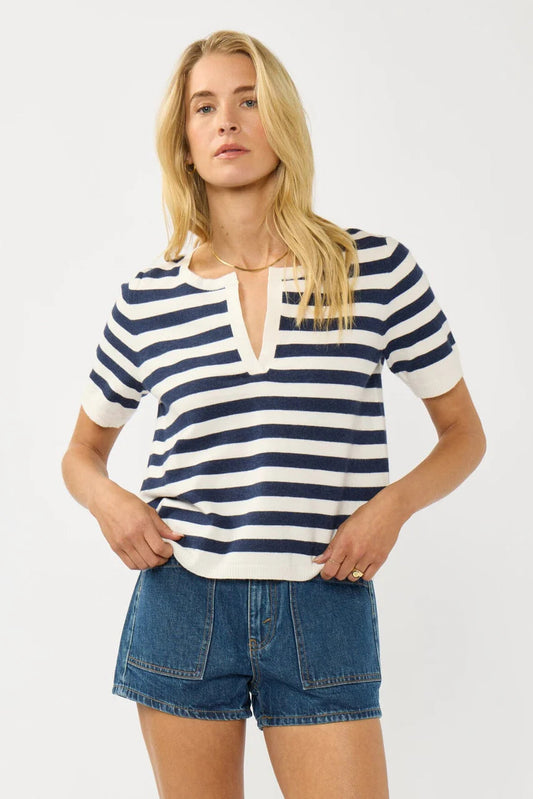 Cream and navy striped polo top with short sleeves, collar, and button placket
