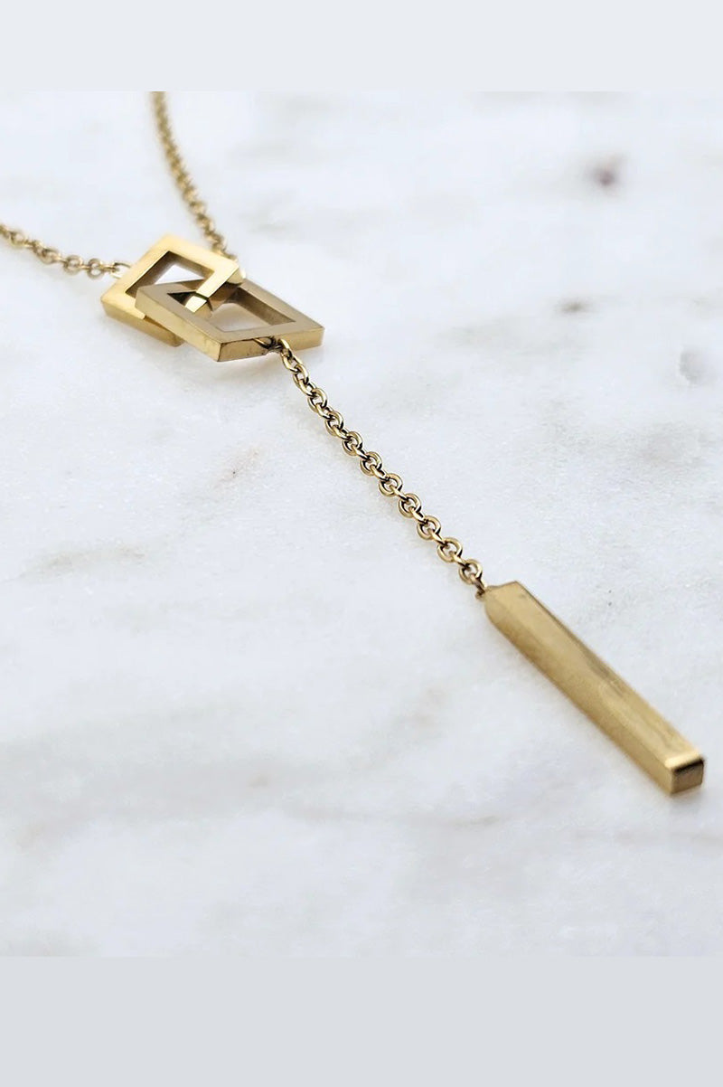 Square lariat necklace in gold closeup