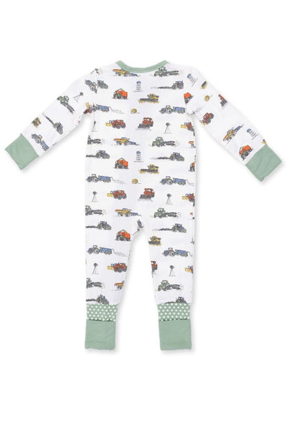 A baby long-sleeve footless one-piece pajama with an all-over farm machines print on a white background, featuring sage green cuffs and hem.
