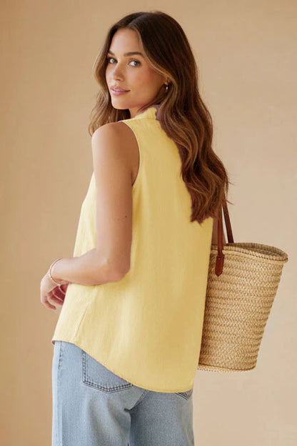 Sleeveless collared half placket top in pale banana back view