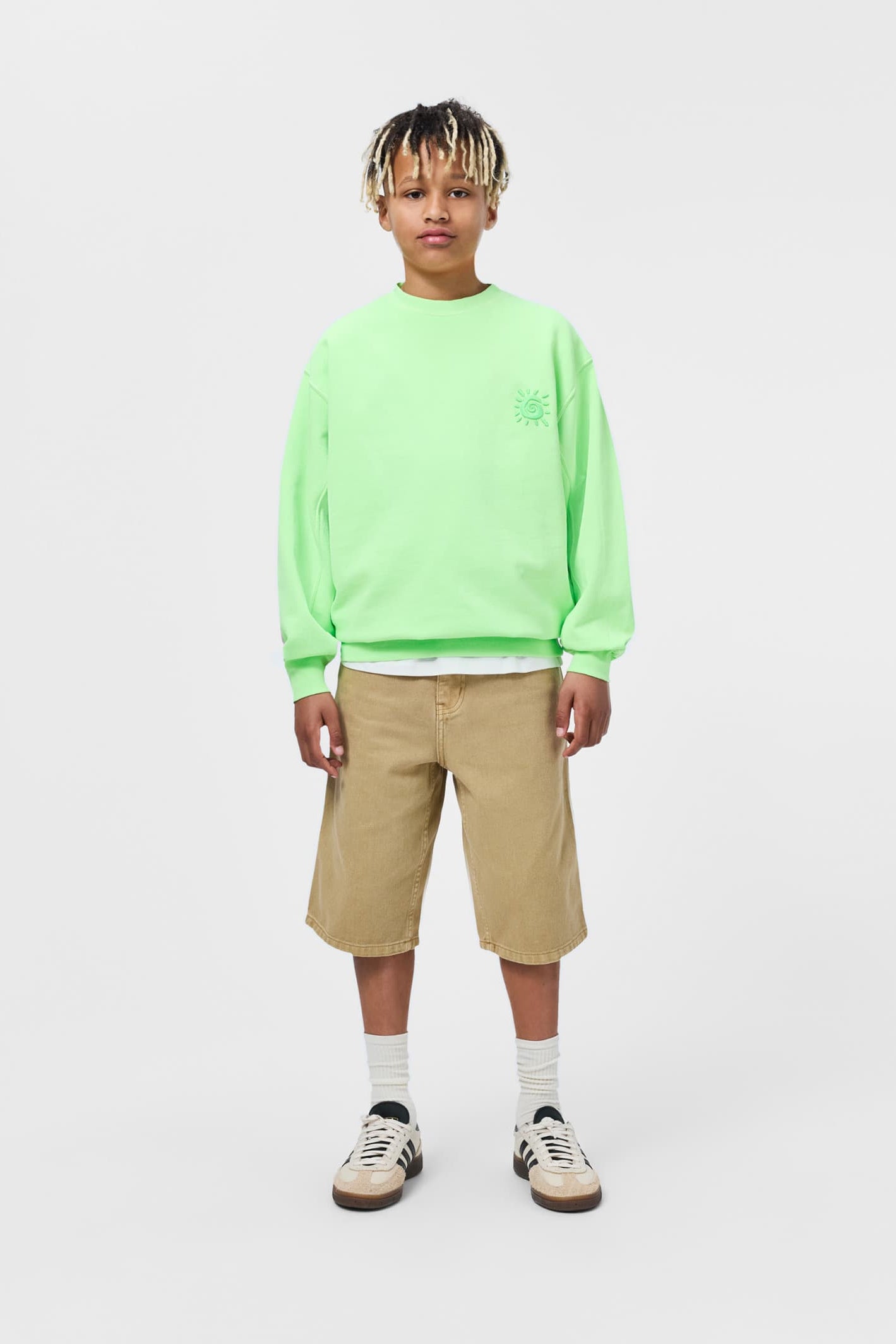Tan desert-wash art shorts for kids, knee length with belt loops and front pockets.