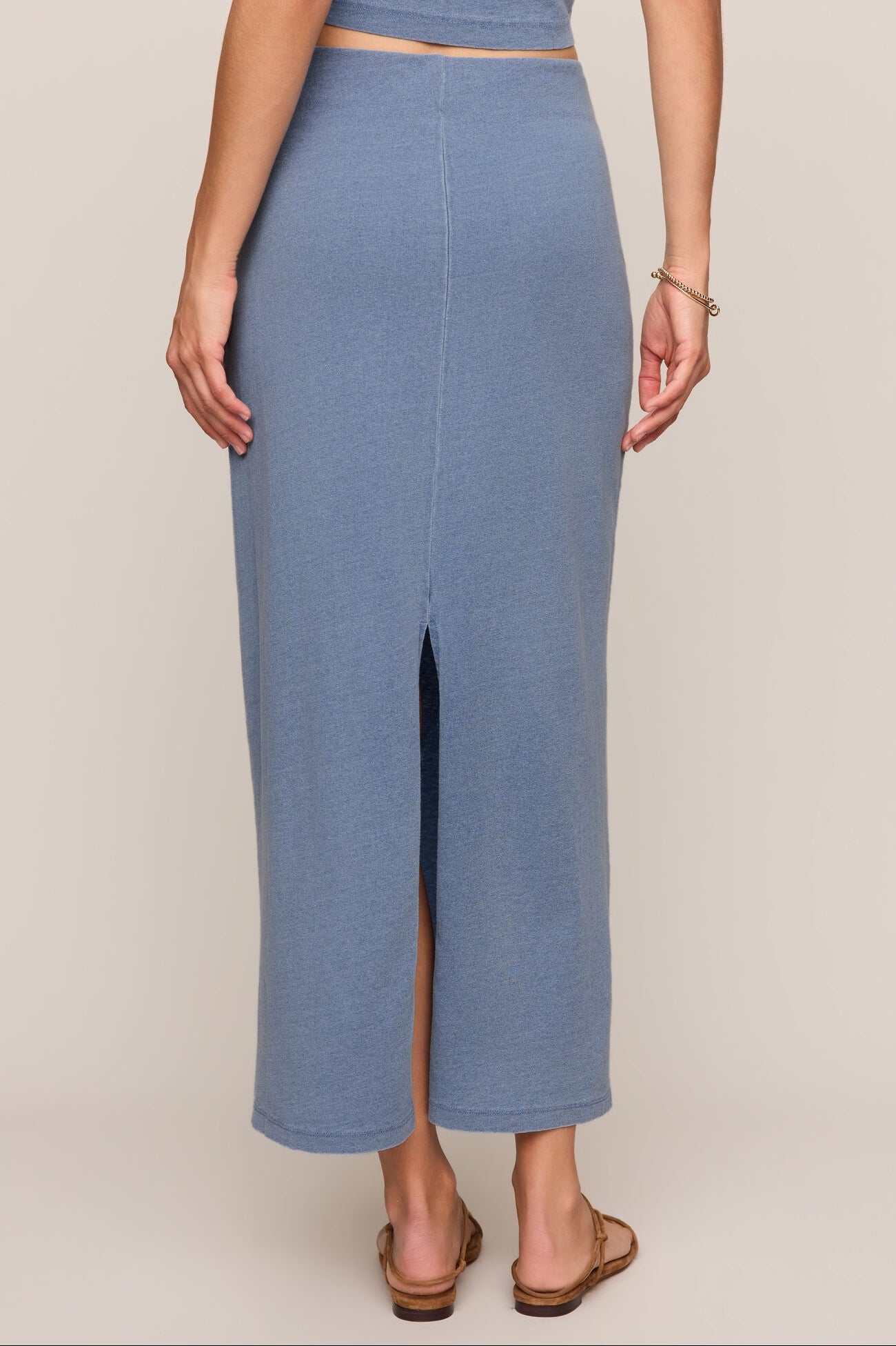Indigo blue jersey denim midi skirt with a front slit opening.