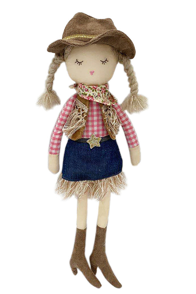 Textile doll dressed as a cowgirl with a hat, plaid shirt, and denim skirt on a white background