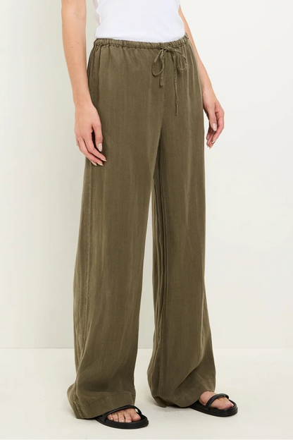 Olive drawstring pants with relaxed wide legs and elastic waistband ties