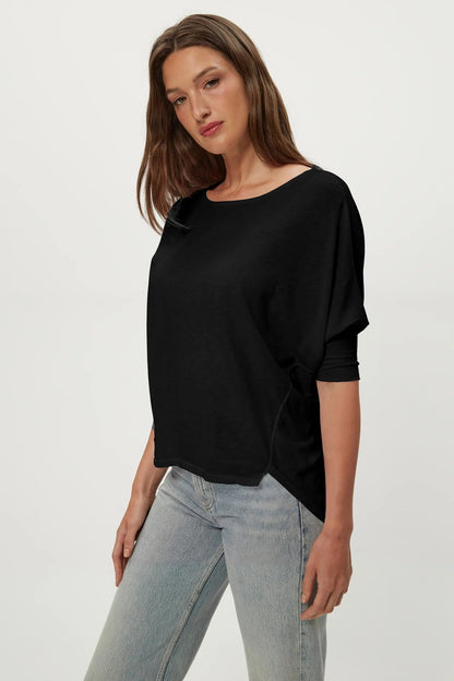 Black dolman tee with crew neck and draped short sleeves, side view