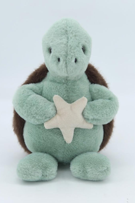 Green plush sea turtle with brown flippers and starfish appliqué on belly