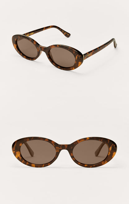Tortoiseshell oval sunglasses with dark gradient lenses