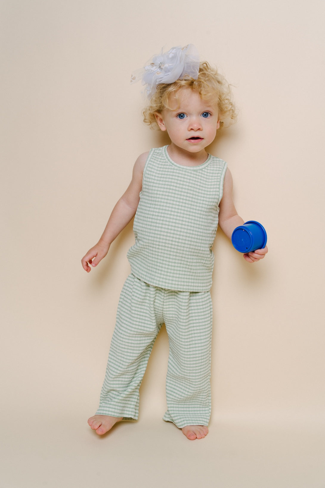 Mint striped sleeveless tank and matching wide-leg pants set on baby, barefoot