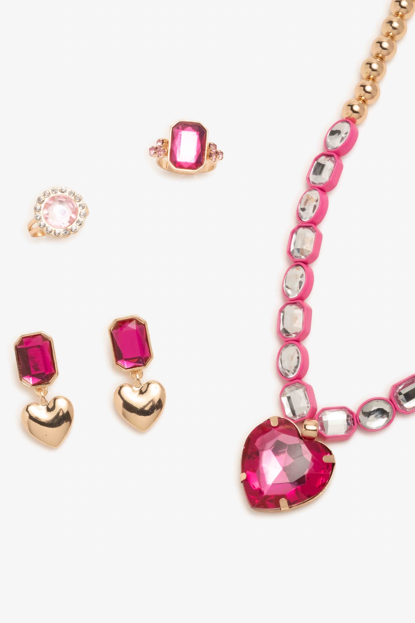 Necklace with pink heart-shaped gemstones and matching earrings on a white background