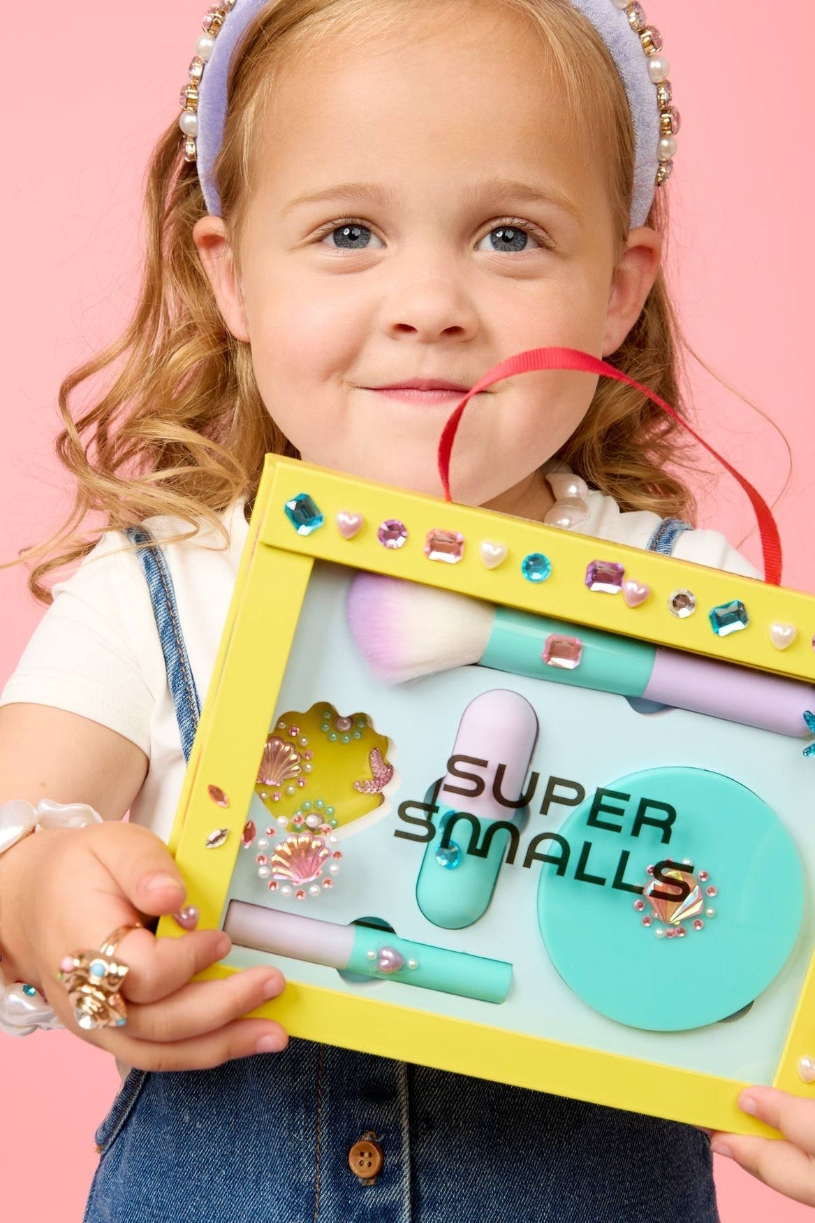 Mermaid makeup play kit with brush, lip color, and accessories in yellow case