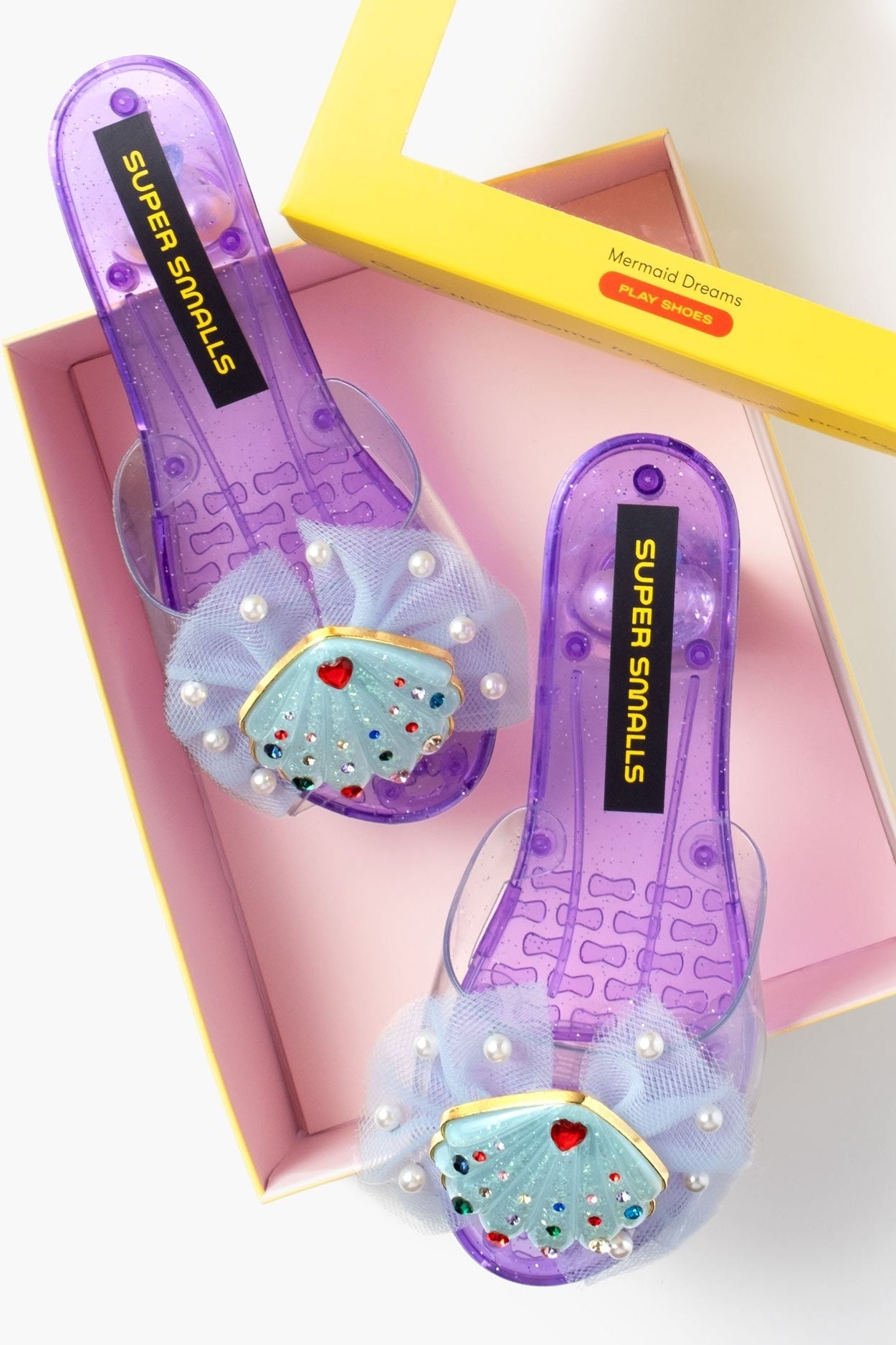 Purple jelly sandals with pearl mesh and turquoise seashell appliques on box