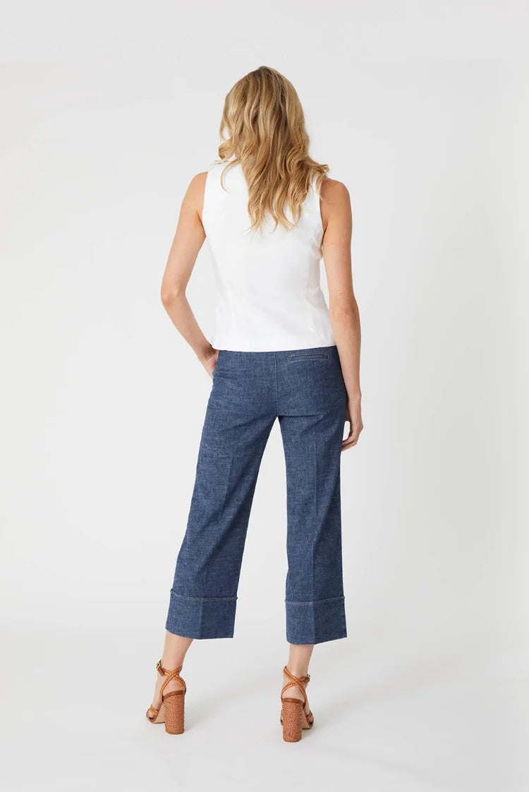 Back view of a woman modeling stargazer color Lauren Cuffed Trouser pants with a white tank top and heels on a plain background 