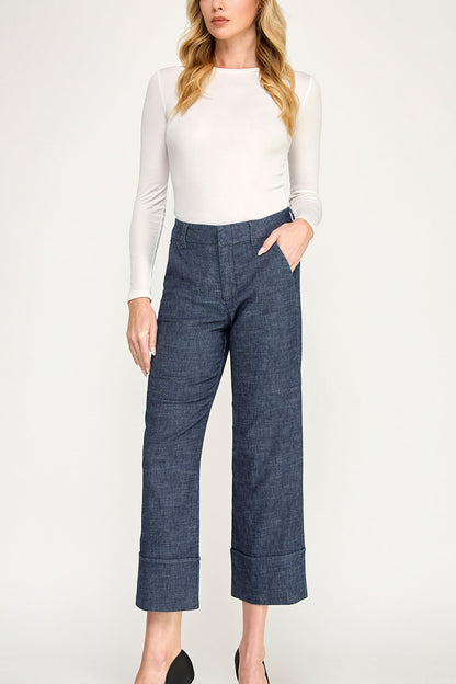 Woman wearing a white long sleeve shirt, Lauren cuffed trouser pants in Stargazer color variant against a plain background