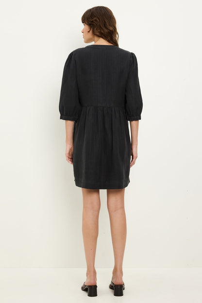 Black back-view mini dress with gathered yoke, 3/4 puff sleeves, and elastic waist