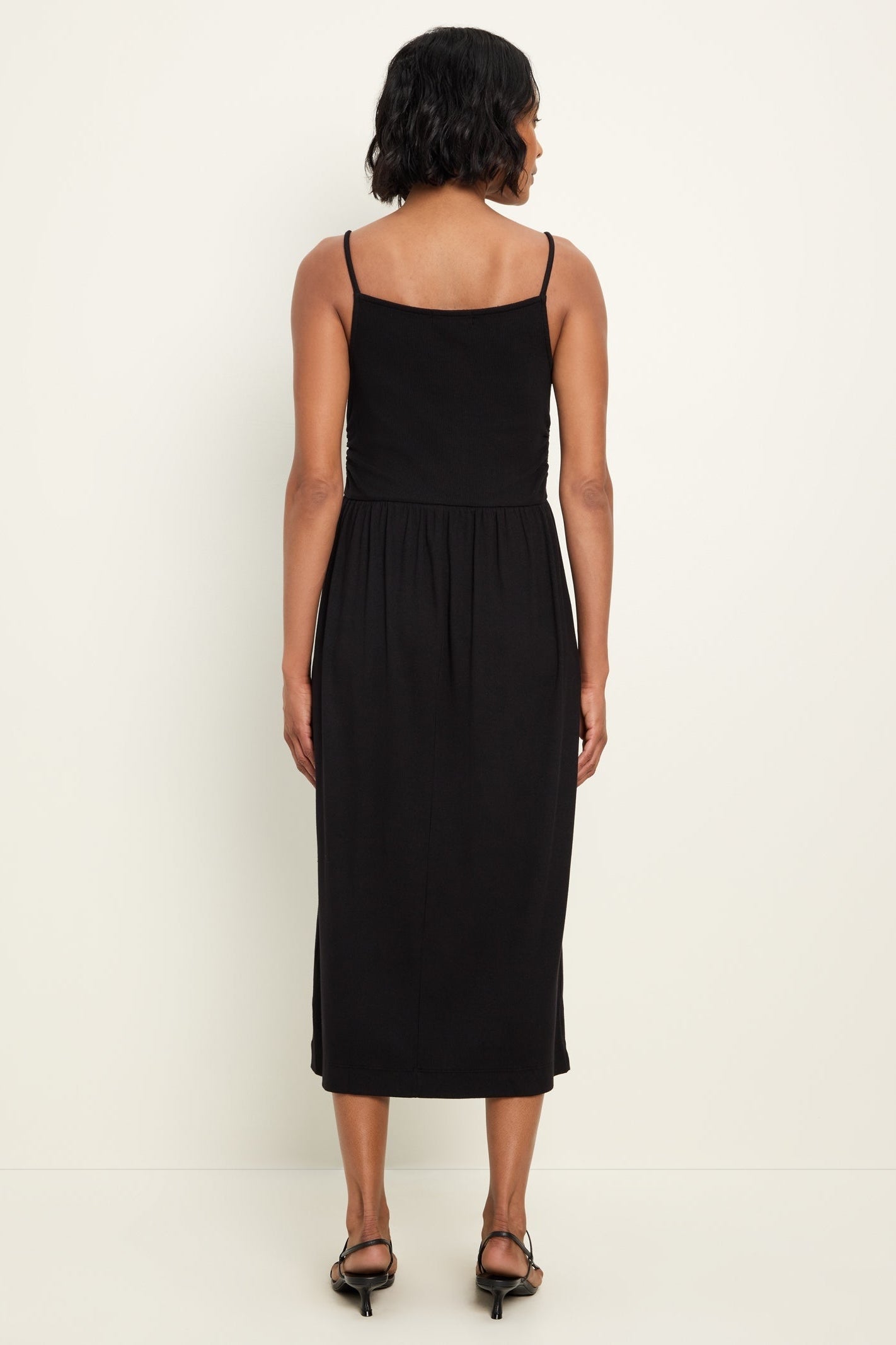 Black square-back midi dress with spaghetti straps and gathered waist