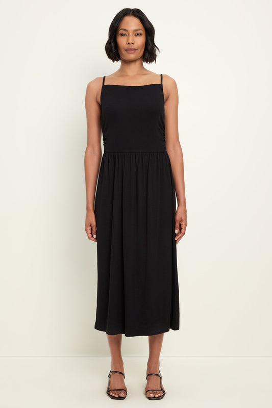 Woman wearing a black sleeveless dress on a white background