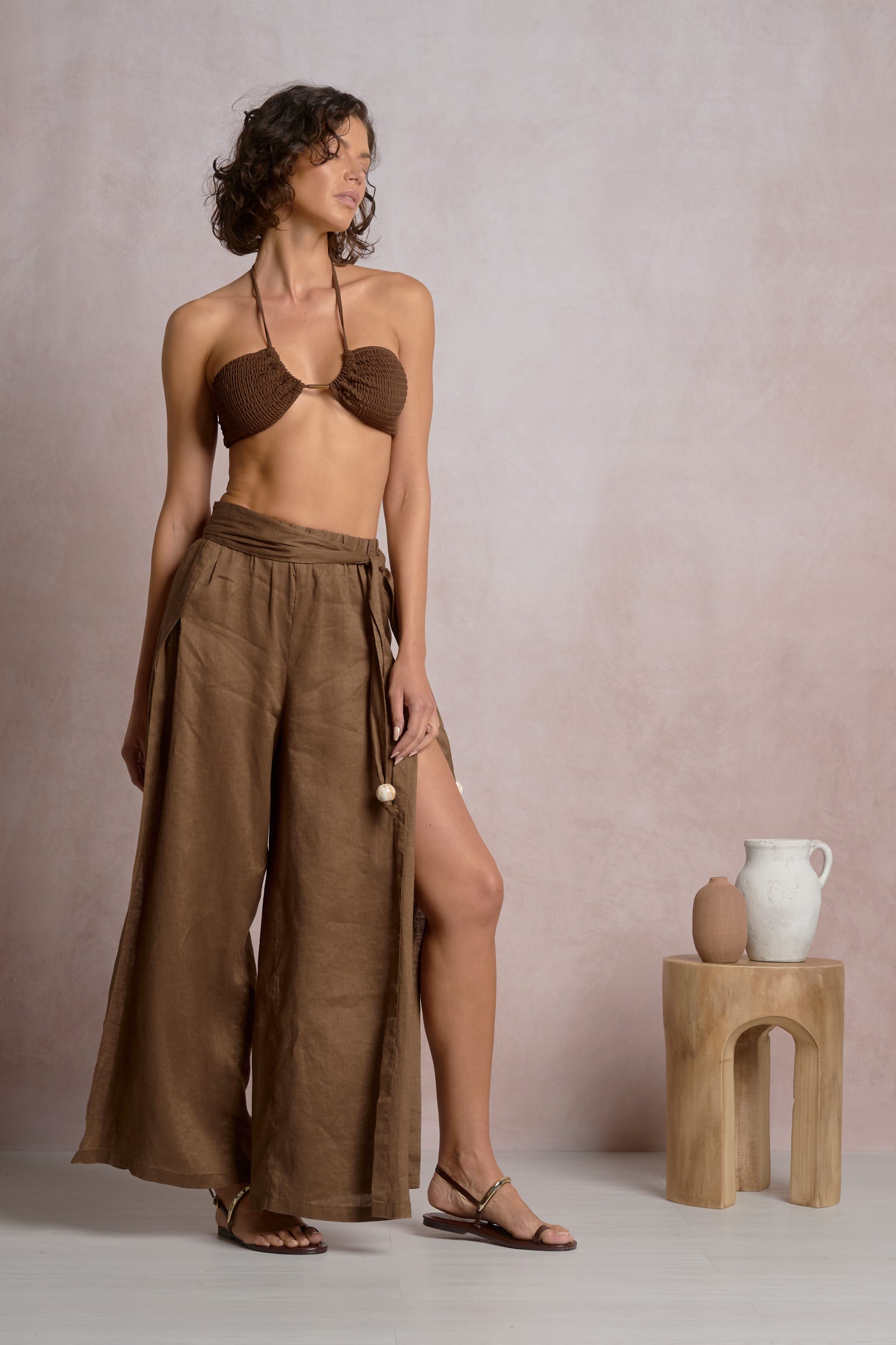 Brown slit side pant with wide legs and drawstring waist, ankle length.