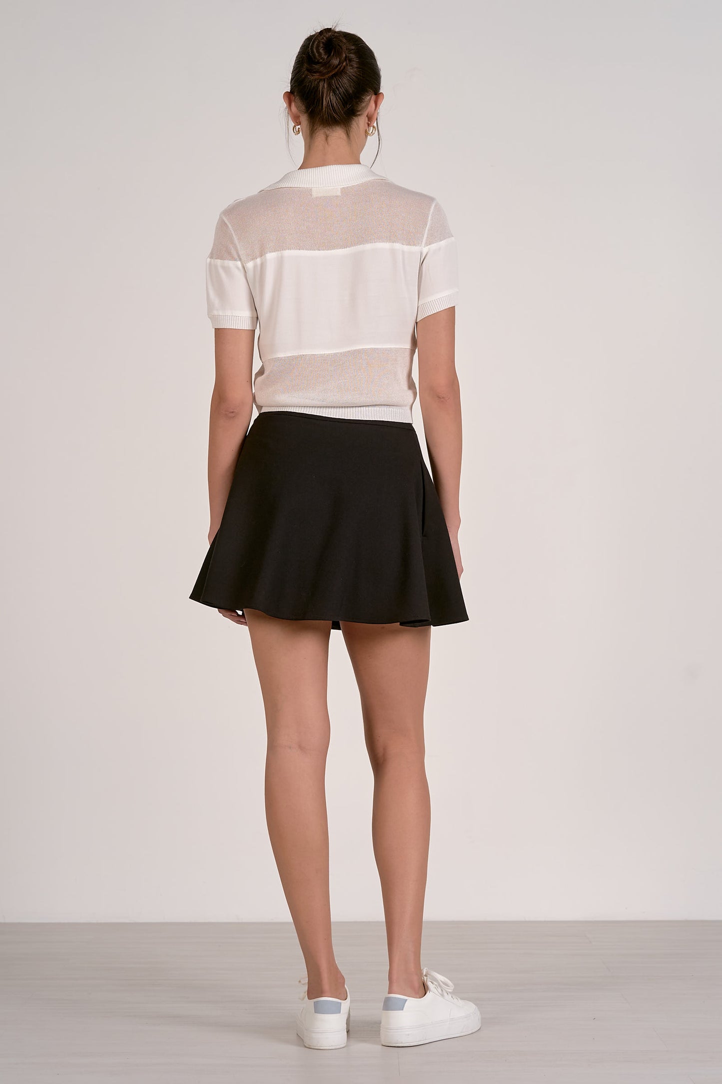 Back of sheer short-sleeve sweater with striped knit and ribbed cuffs, no buttons visible