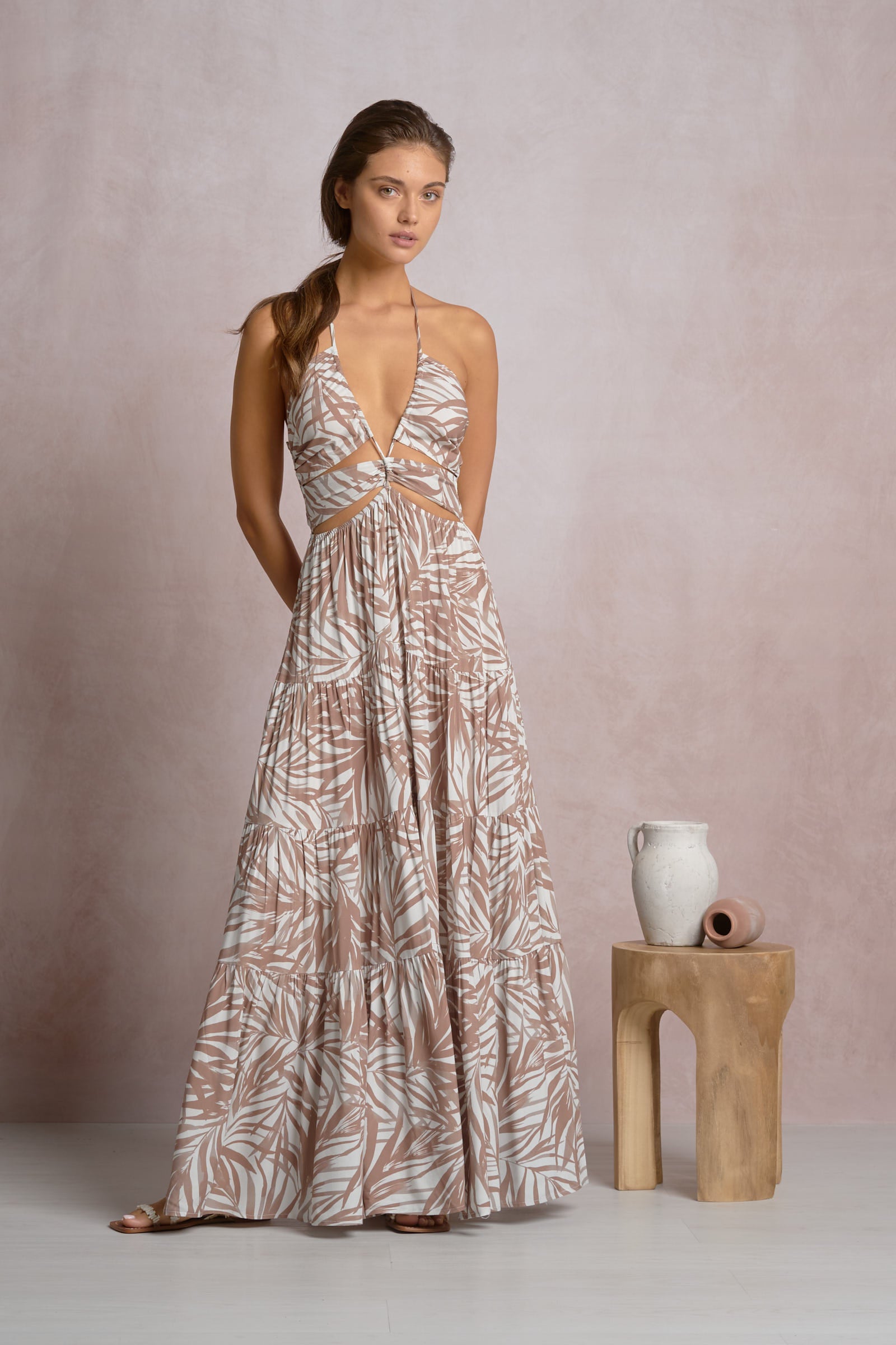 Cut out maxi dress in beige tropical leaf print, halter V-neck and tiered full skirt