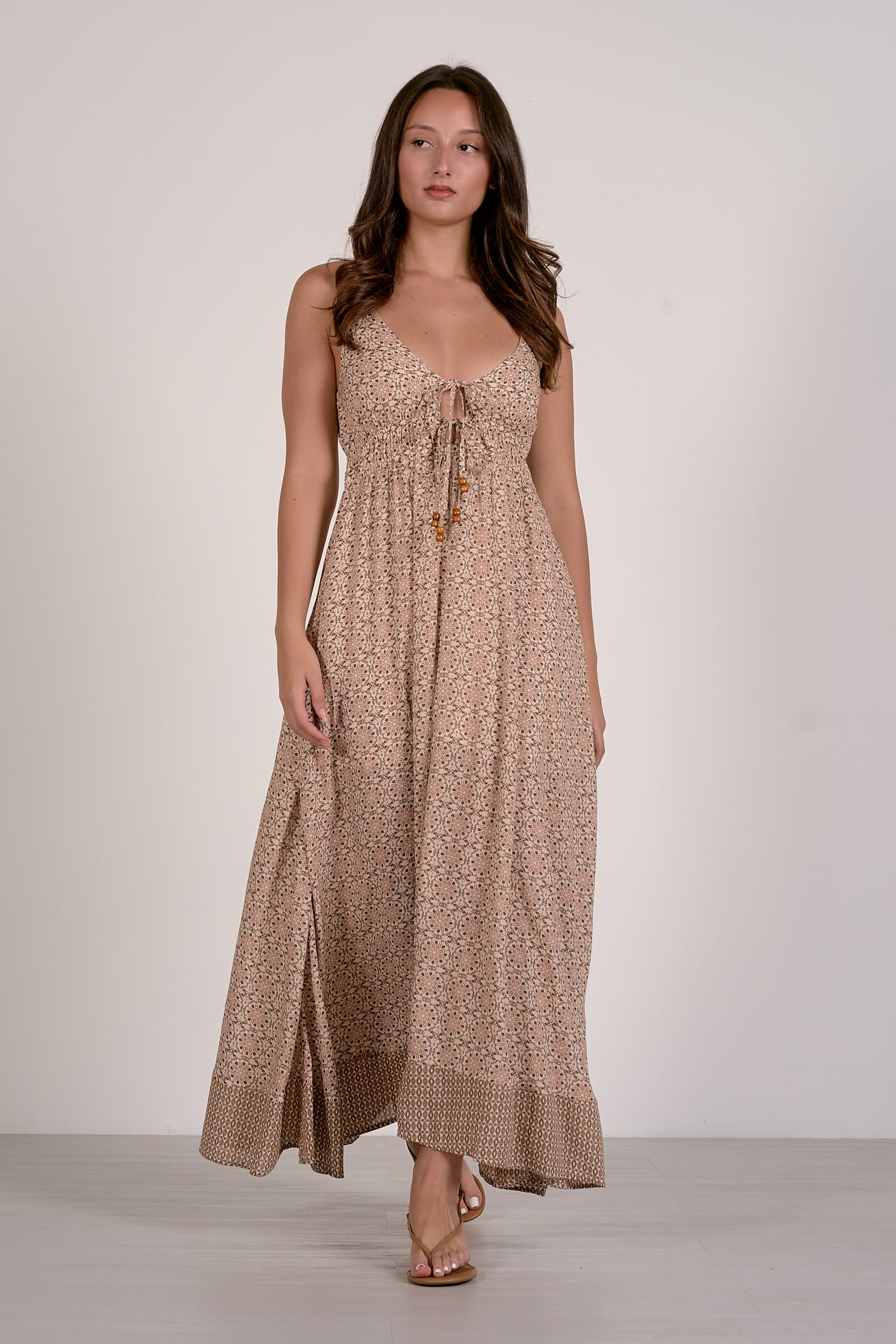 Beige boho maxi dress with spaghetti straps, V-neck, and front tie detail