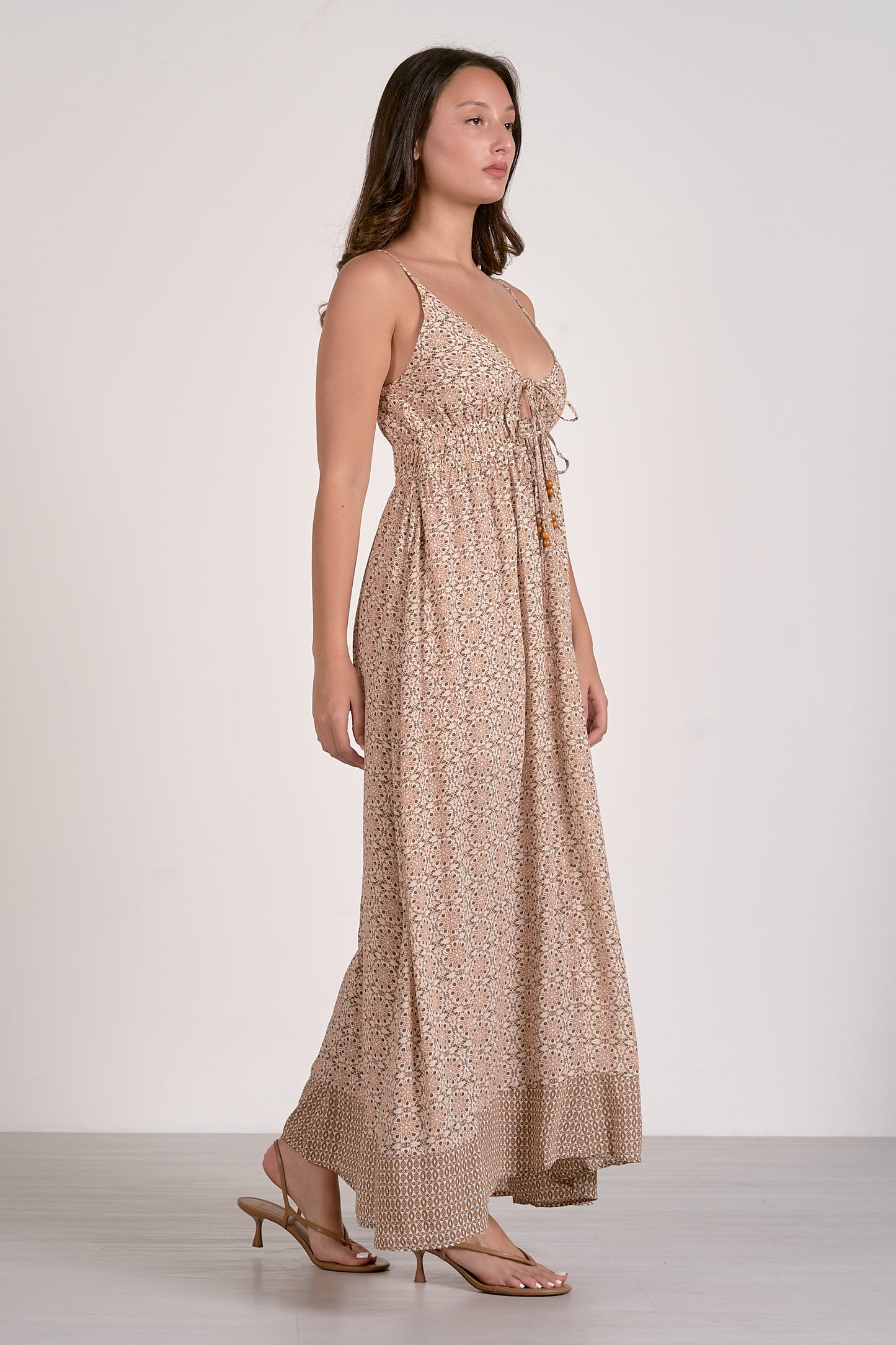 Beige boho maxi dress with spaghetti straps, gathered bodice, and tiered skirt