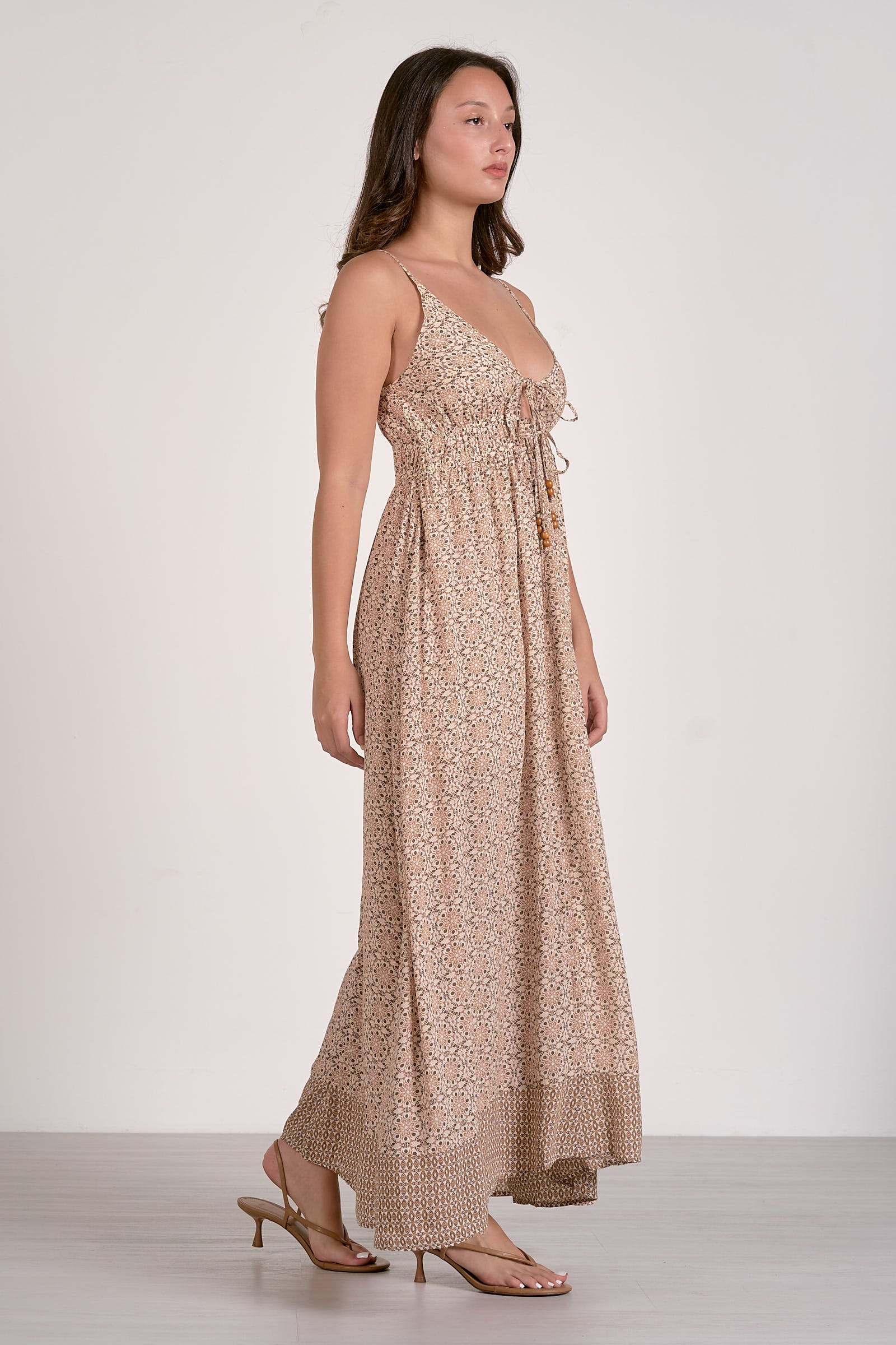Beige boho maxi dress with spaghetti straps, gathered bodice, and tiered skirt