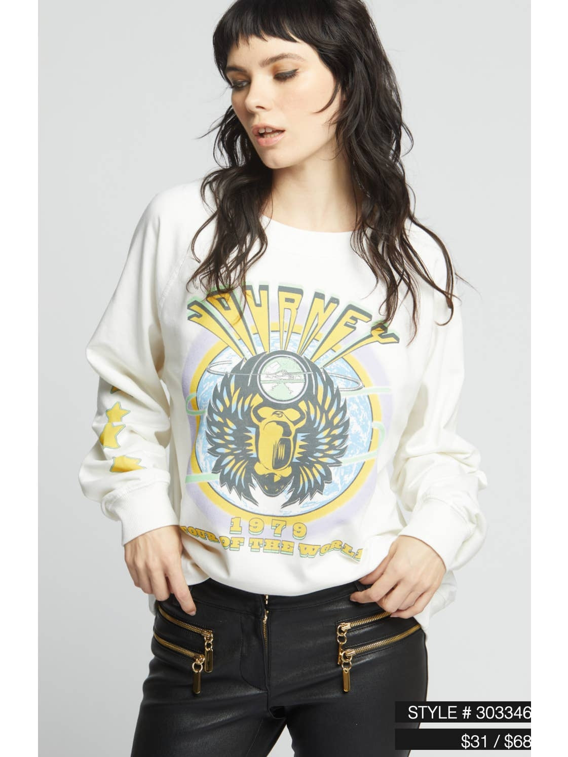 Cream crewneck sweatshirt with eagle face graphic, worn with long sleeves