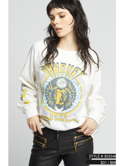 Cream crewneck sweatshirt with eagle face graphic, worn with long sleeves