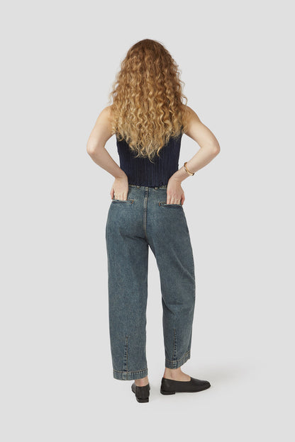 Denim trousers in dark wash, back view with wide straight legs and stitched pockets