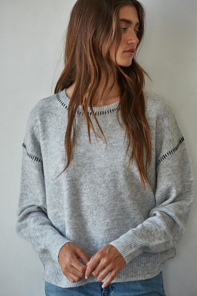 Heather grey crewneck sweater with black knit trim on sleeves and neckline
