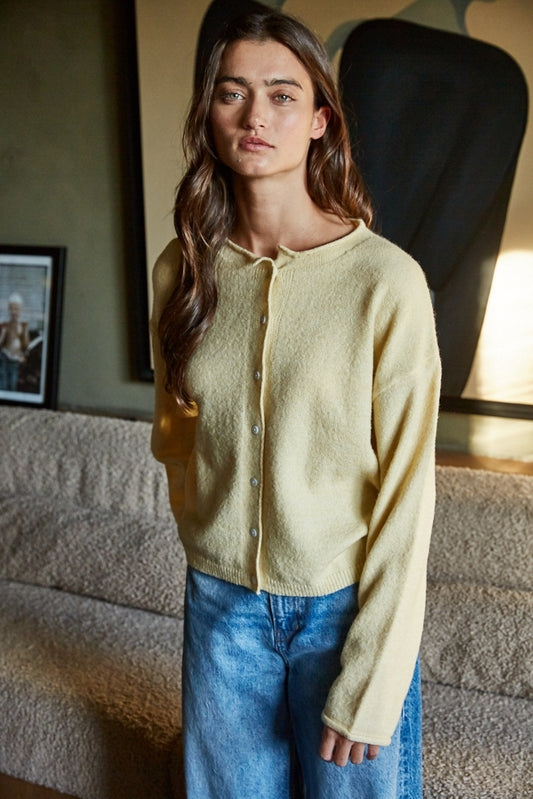 Butter-yellow knit cardigan top with button-front placket and long sleeves