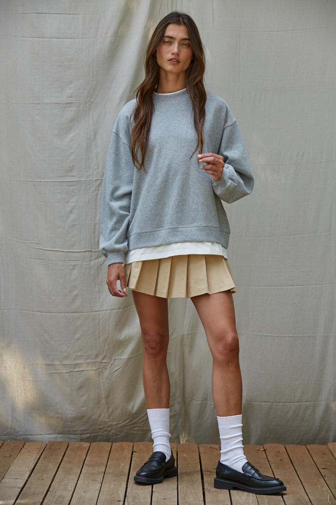 Heather grey crewneck pullover with layered hem and relaxed sleeves