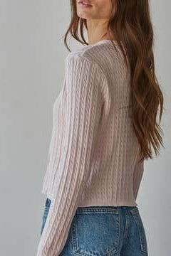 Ballet pink cable knit cardigan top, side view with button placket and ribbed hem