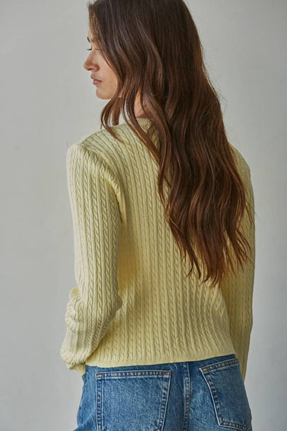 Butter yellow cable knit cardigan top, close side view with textured vertical cable pattern