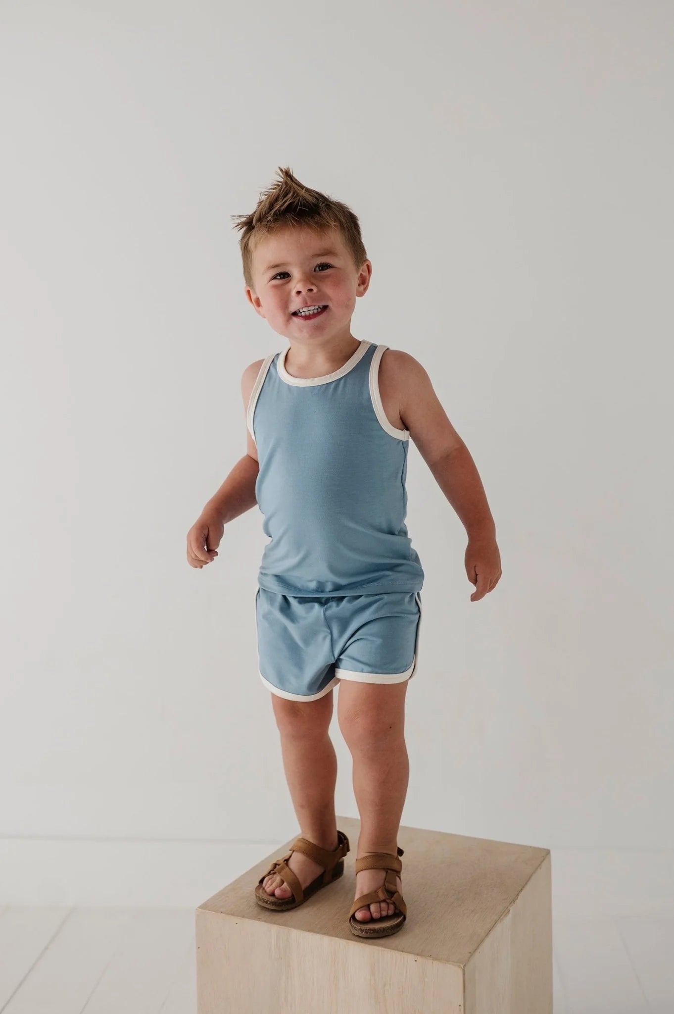 Light blue kids track set with sleeveless tank and matching shorts.