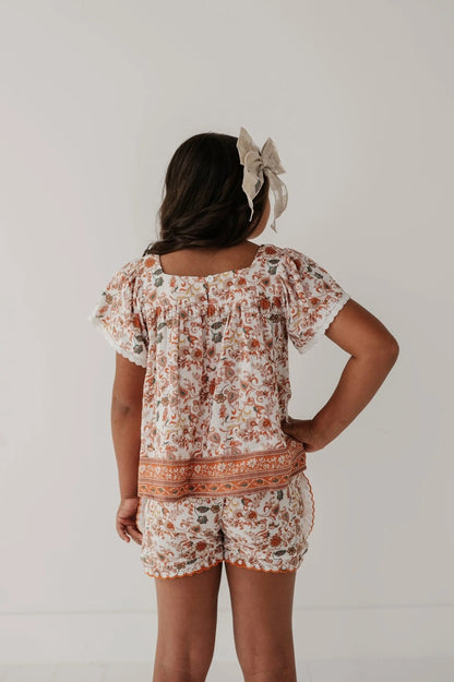Back view: square-neck peasant top with lace-trim sleeves and gathered waist