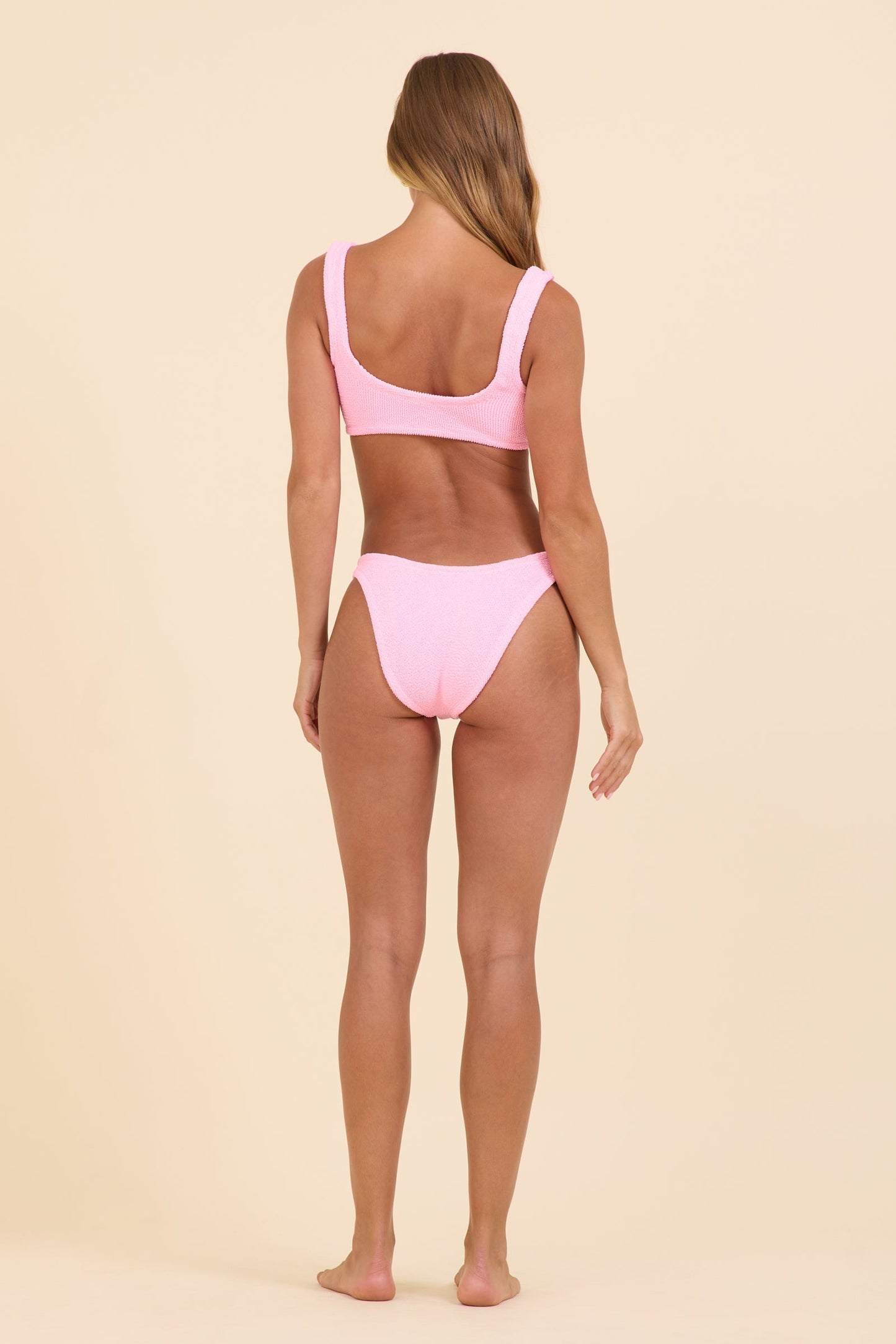 Pink O-ring bikini top with back strap and paired high-cut bikini bottoms
