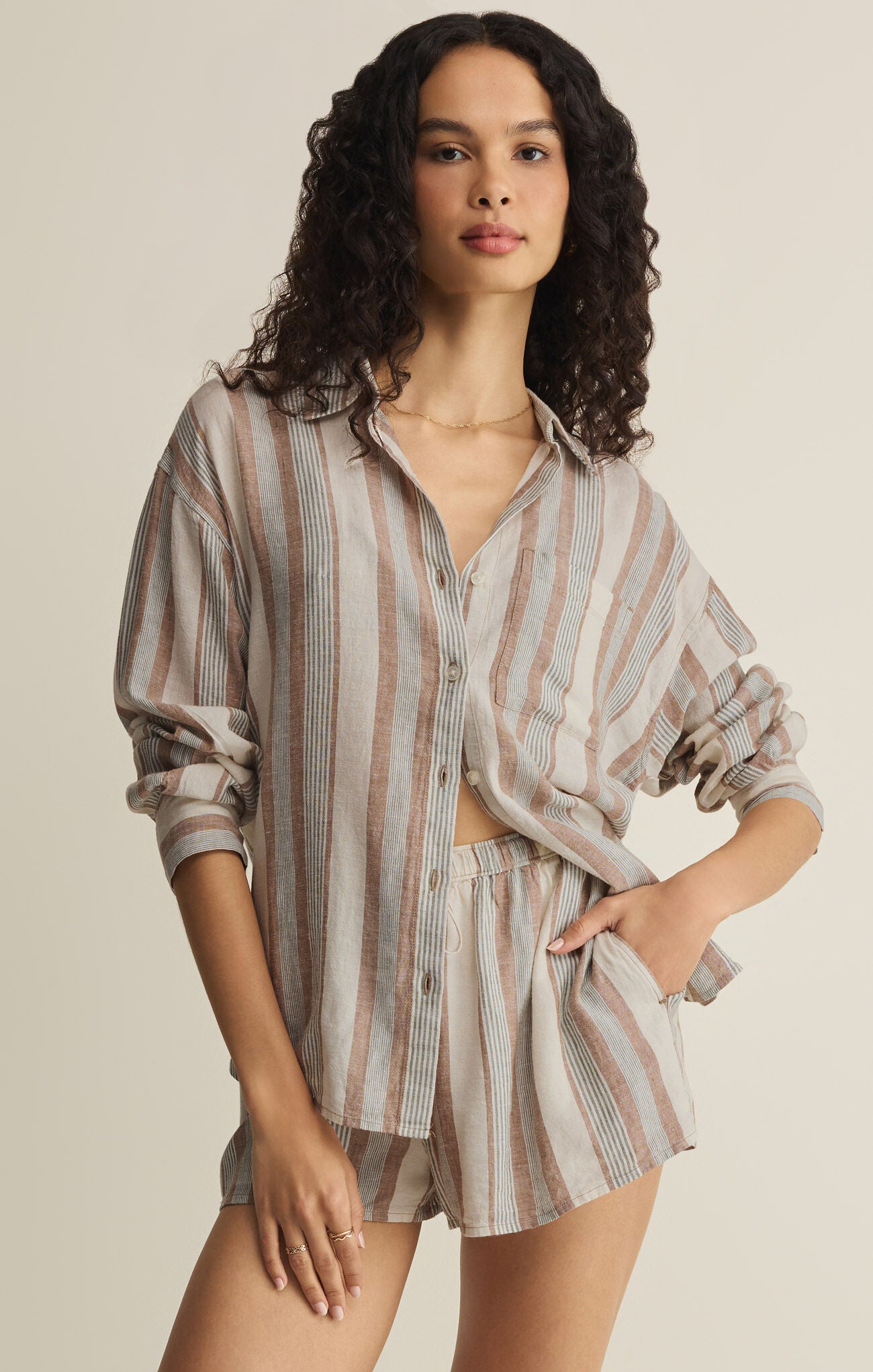 Striped button-up shirt with front buttons, long sleeves, and chest pocket in light beige