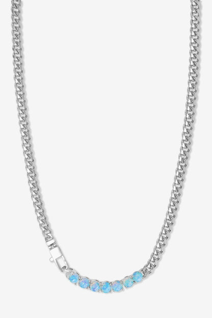 Silver chain necklace with blue stones on a white background