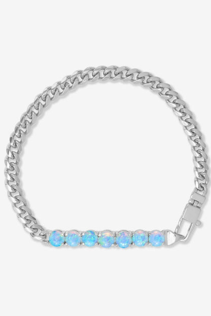Silver chain bracelet with blue gemstones on a white background
