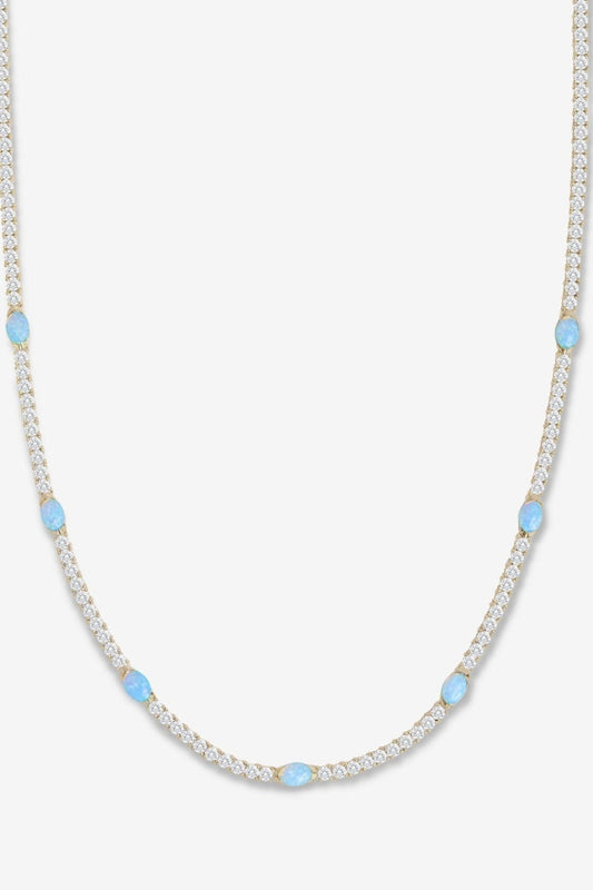 Gold and blue necklace on a white backdrop
