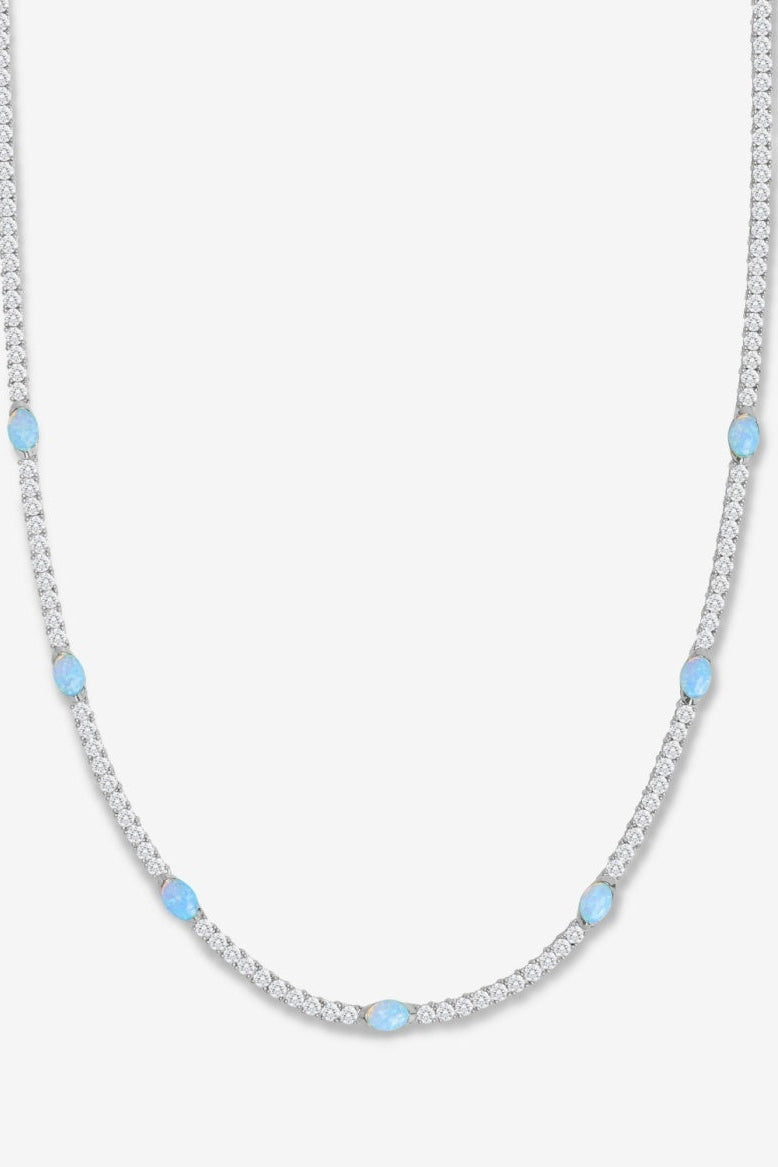 Silver and blue necklace on white backdrop