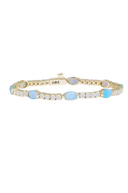 Gold-tone tennis bracelet with blue oval stones and crystal links