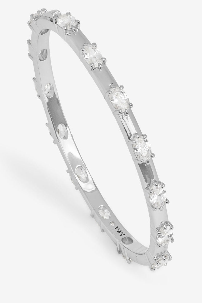 Silver bracelet with embedded diamonds on a white background