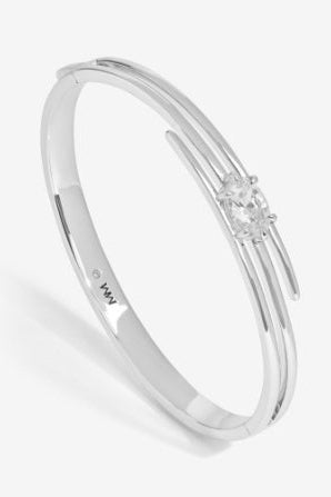 Silver bracelet with a small decorative element on a light gray background