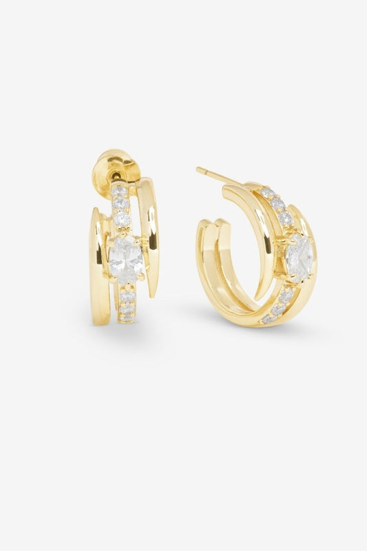 Gold hoop earrings with embedded diamonds on a white background