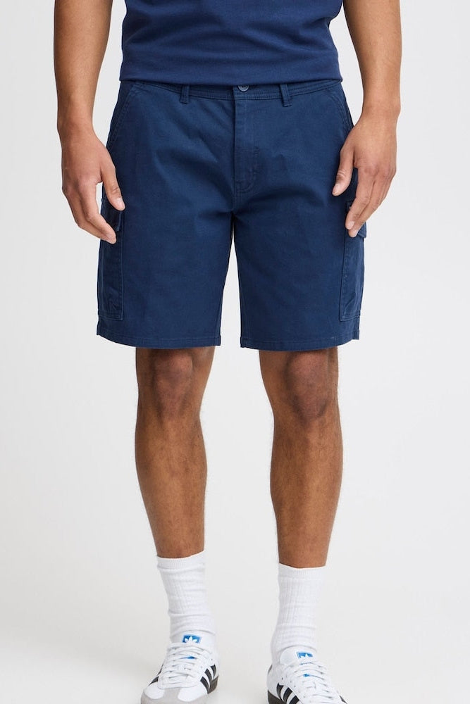 Front view of navy cargo shorts on a man on a white background